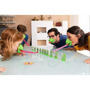 Gyerekek és felnőttek együtt játszanak, kaméleonmaszkban próbálják elkapni a kártyákat az asztalon.