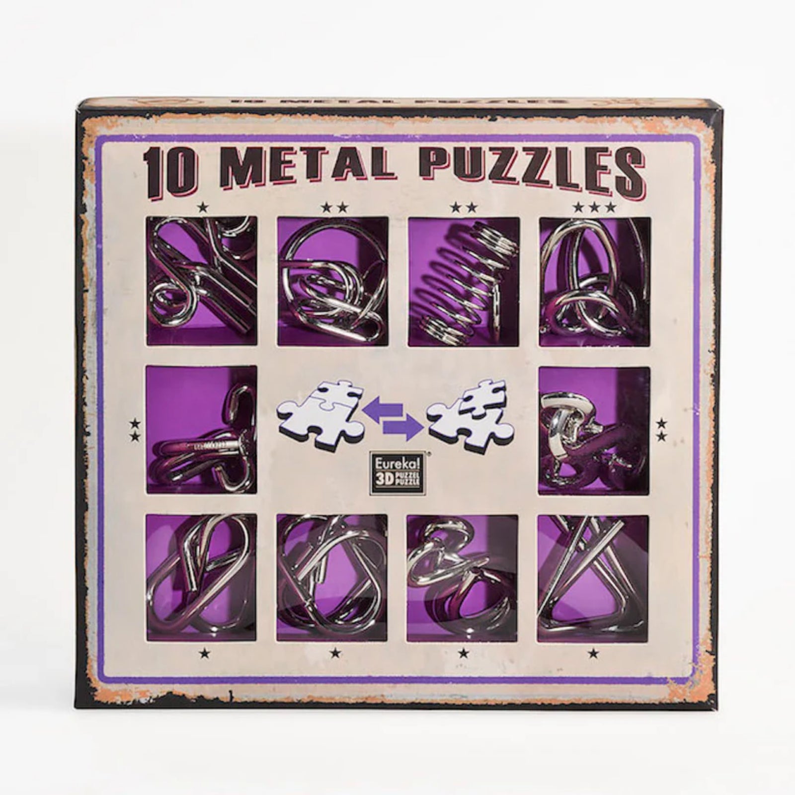 Négyzet alakú kartondoboz, amely tíz különböző fémből készült logikai kirakót tartalmaz, lila háttérrel és „10 Metal Puzzles” felirattal, középen két puzzle darab grafikájával.