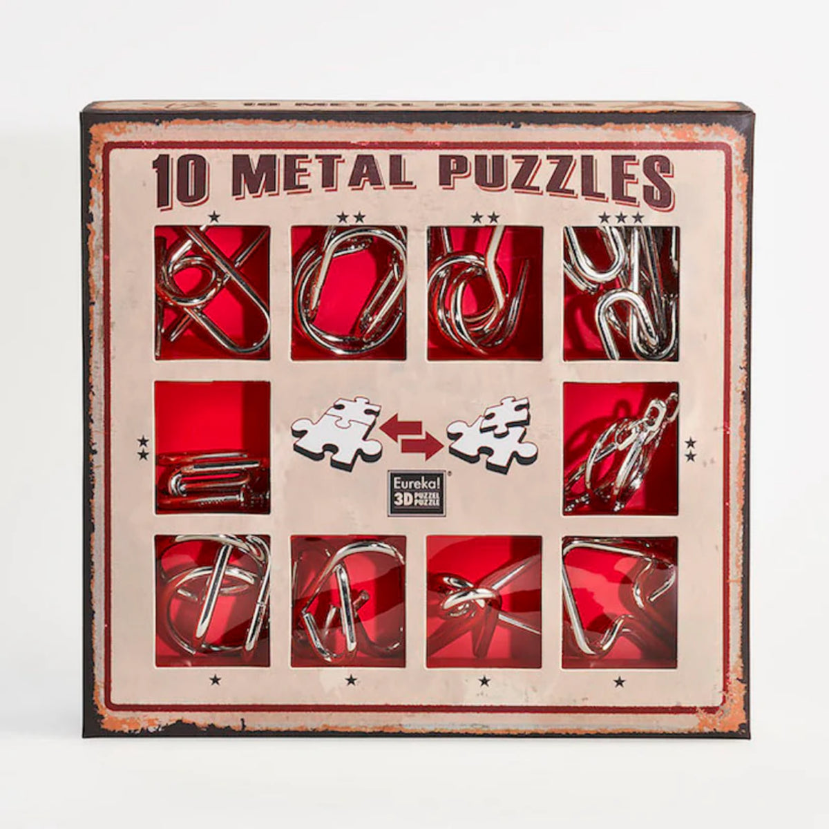 A 10 Metal Puzzle Set díszdoboza, amely piros háttérrel és retró stílusú barna kerettel emeli ki a tíz különböző formájú fém logikai játékot; a doboz elején kirakós darabokat ábrázoló ikonok és a Eureka! 3D Puzzle logó is látható.