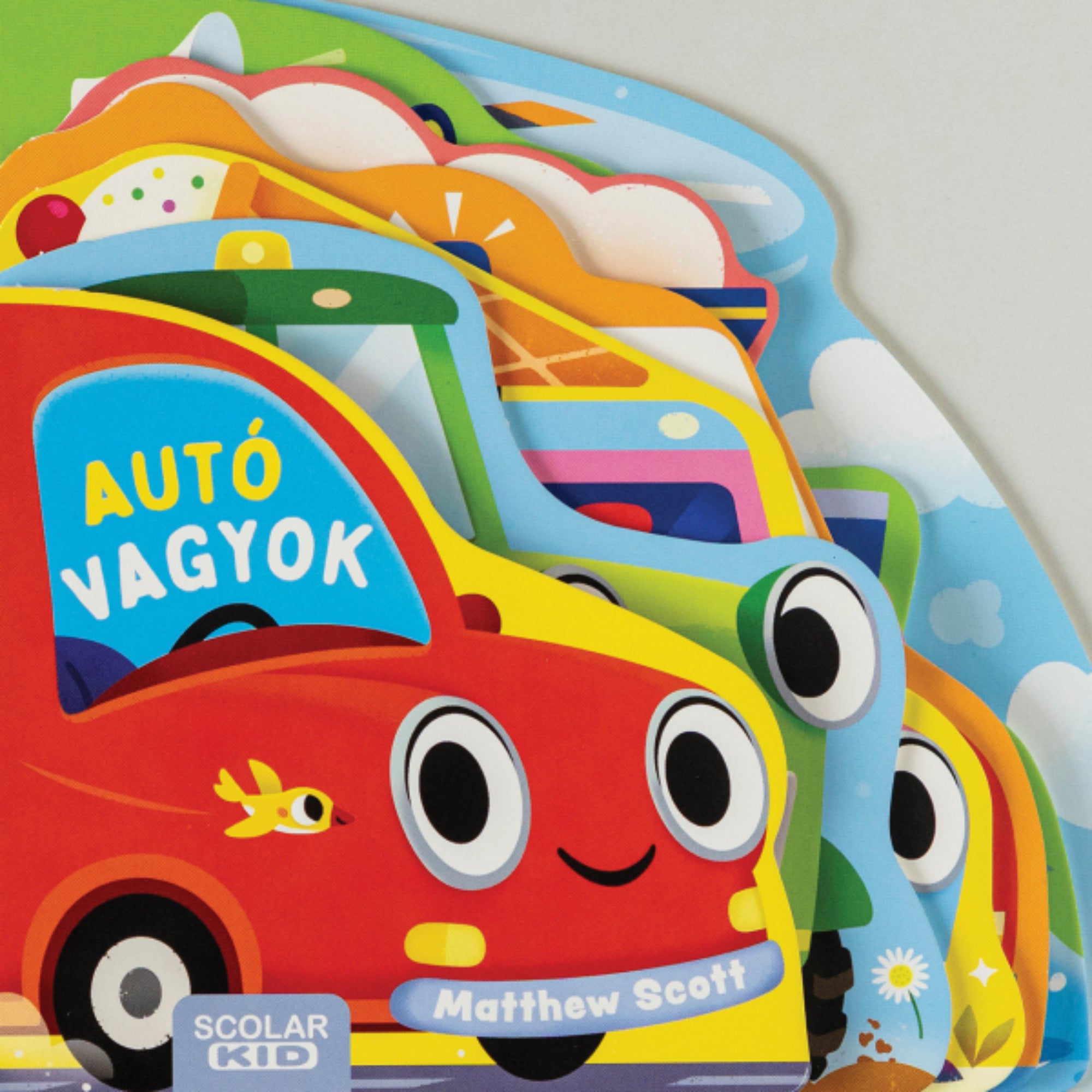 Az Autó vagyok című gyerekkönyv borítója, színes, mosolygós járműveket ábrázoló kivágott formájú lapokkal, a Scolar Kid kiadásában.