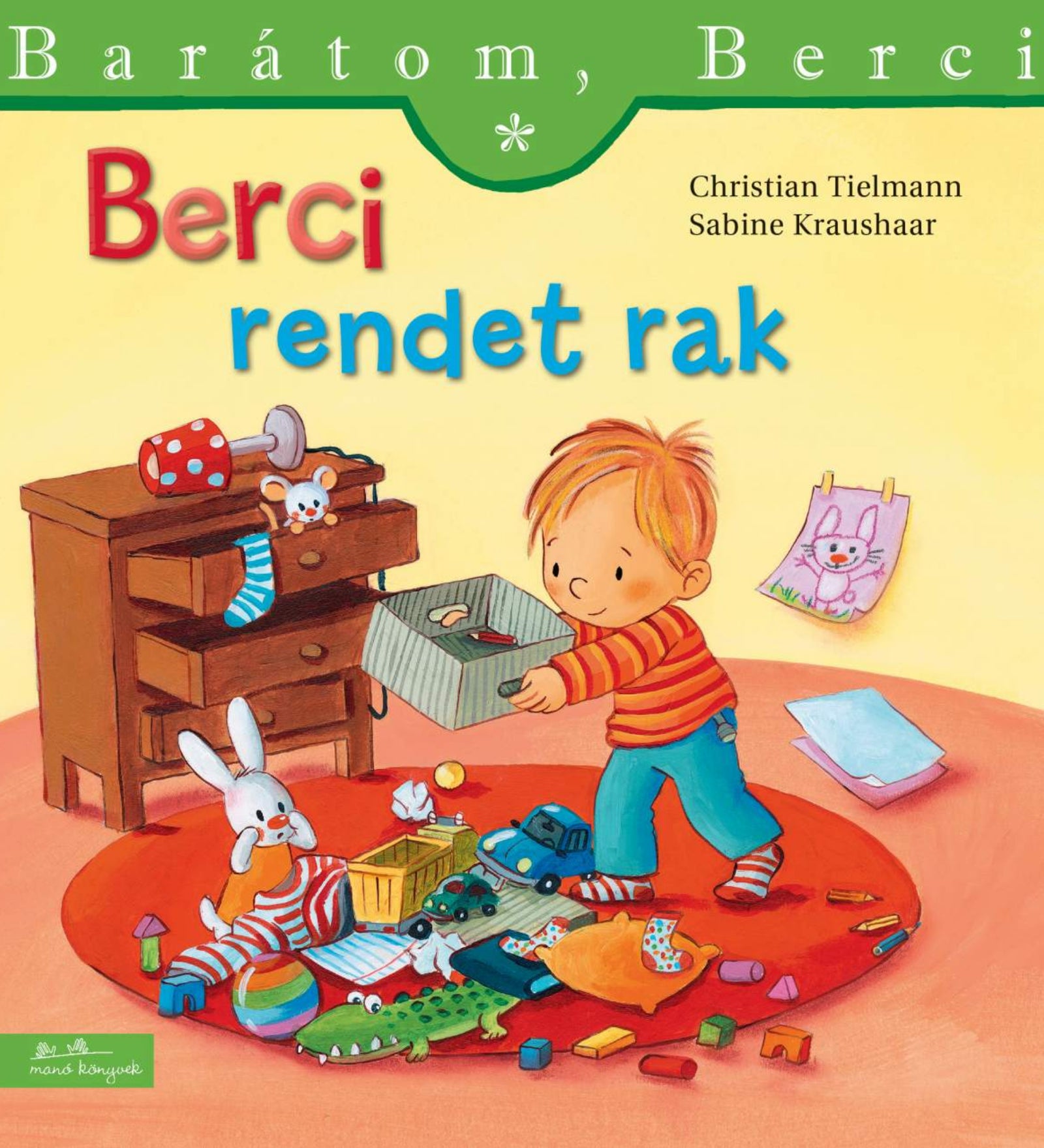 “Berci rendet rak” könyv borító – Berci a földre szétszórt játékokat pakolja látható dobozba, mögötte fiókos komód és a falon egy rajz.