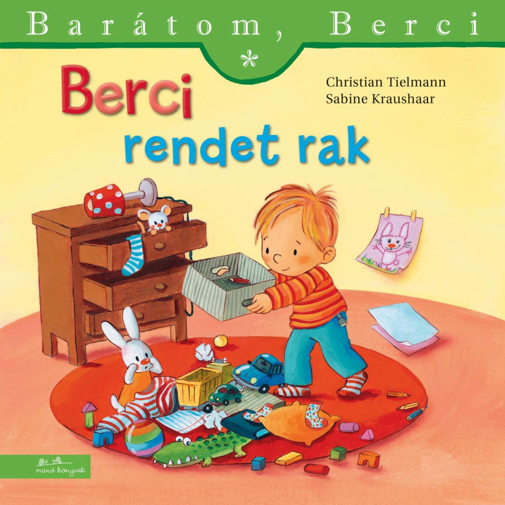 “Berci rendet rak” könyv borító – Berci a földre szétszórt játékokat pakolja látható dobozba, mögötte fiókos komód és a falon egy rajz.