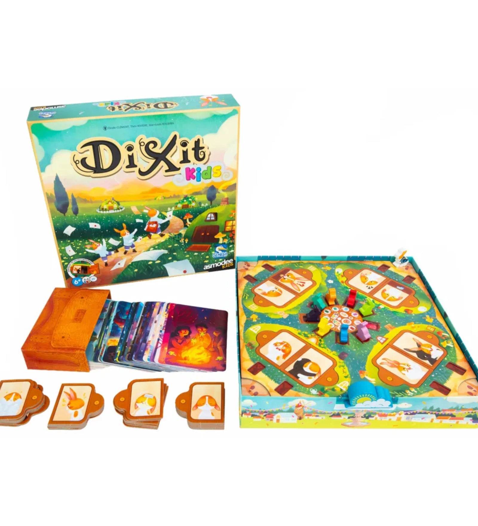 Dixit Kids társasjáték teljes tartalma kiterítve, dobozzal, kártyákkal, figurákkal és játéktáblával.