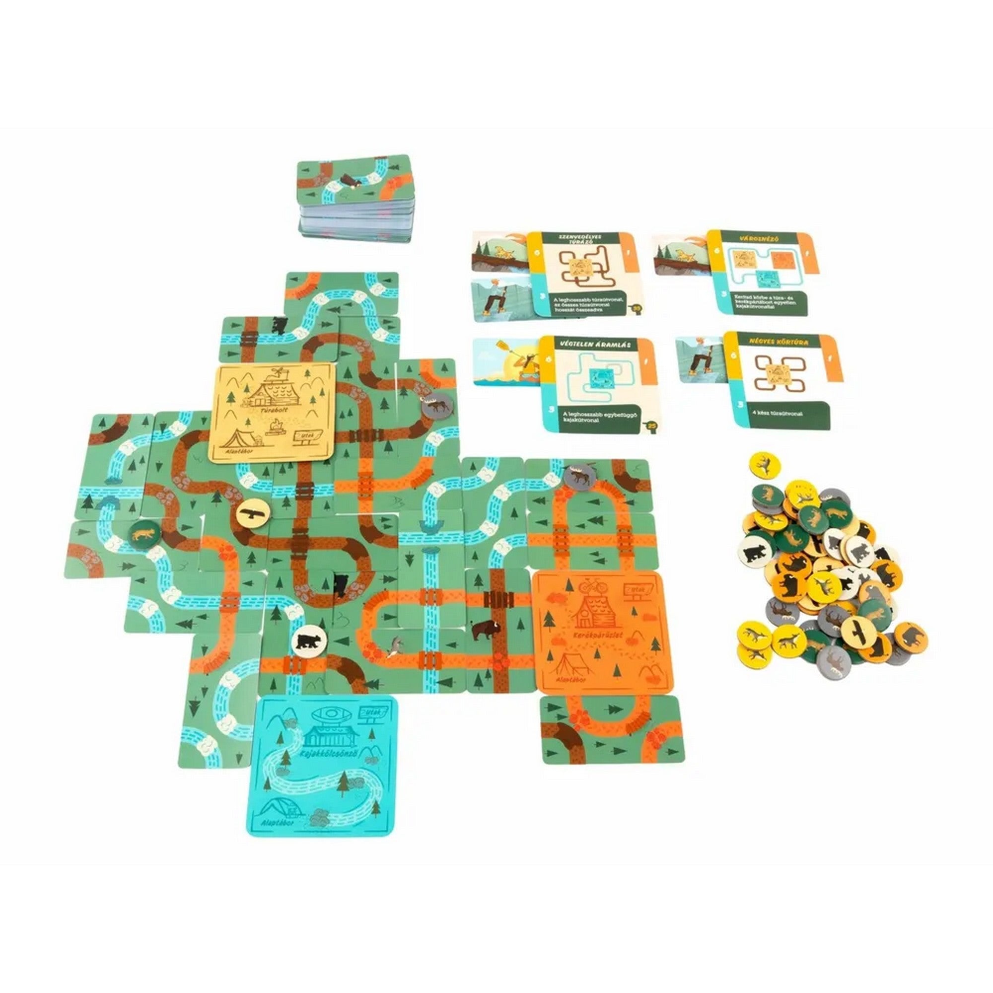 „A Kalandtúra társasjáték pályája kirakva útvonal- és folyókártyákkal, valamint állatjelölőkkel.”