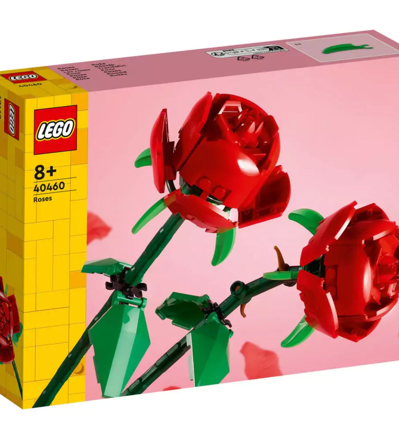 Közelről látható LEGO Rózsák (40460) készlet doboza, amely két élénk piros rózsát ábrázol sötétzöld szárakkal és levelekkel, rózsaszín háttéren.