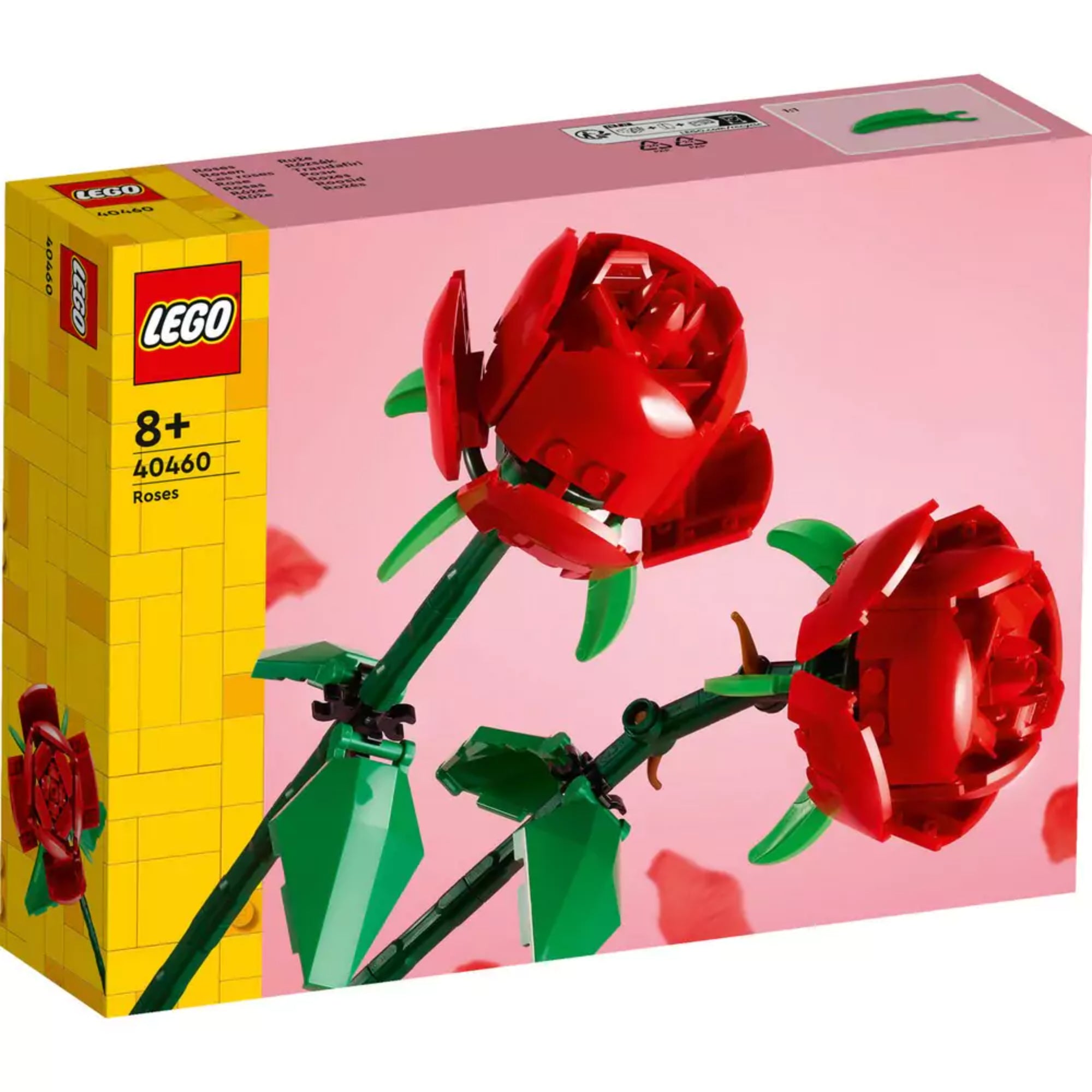 Közelről látható LEGO Rózsák (40460) készlet doboza, amely két élénk piros rózsát ábrázol sötétzöld szárakkal és levelekkel, rózsaszín háttéren.