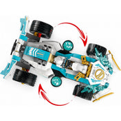 A LEGO NINJAGO versenyautó felülnézeti képe, amely a jármű forgatható kerekmechanikáját szemlélteti piros nyilakkal.