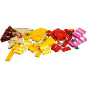 A LEGO Super Mario Kreatív építés szett (71418) sárga, piros és rózsaszín pályaelemei, föld- és lávatémájú kiegészítőkkel.