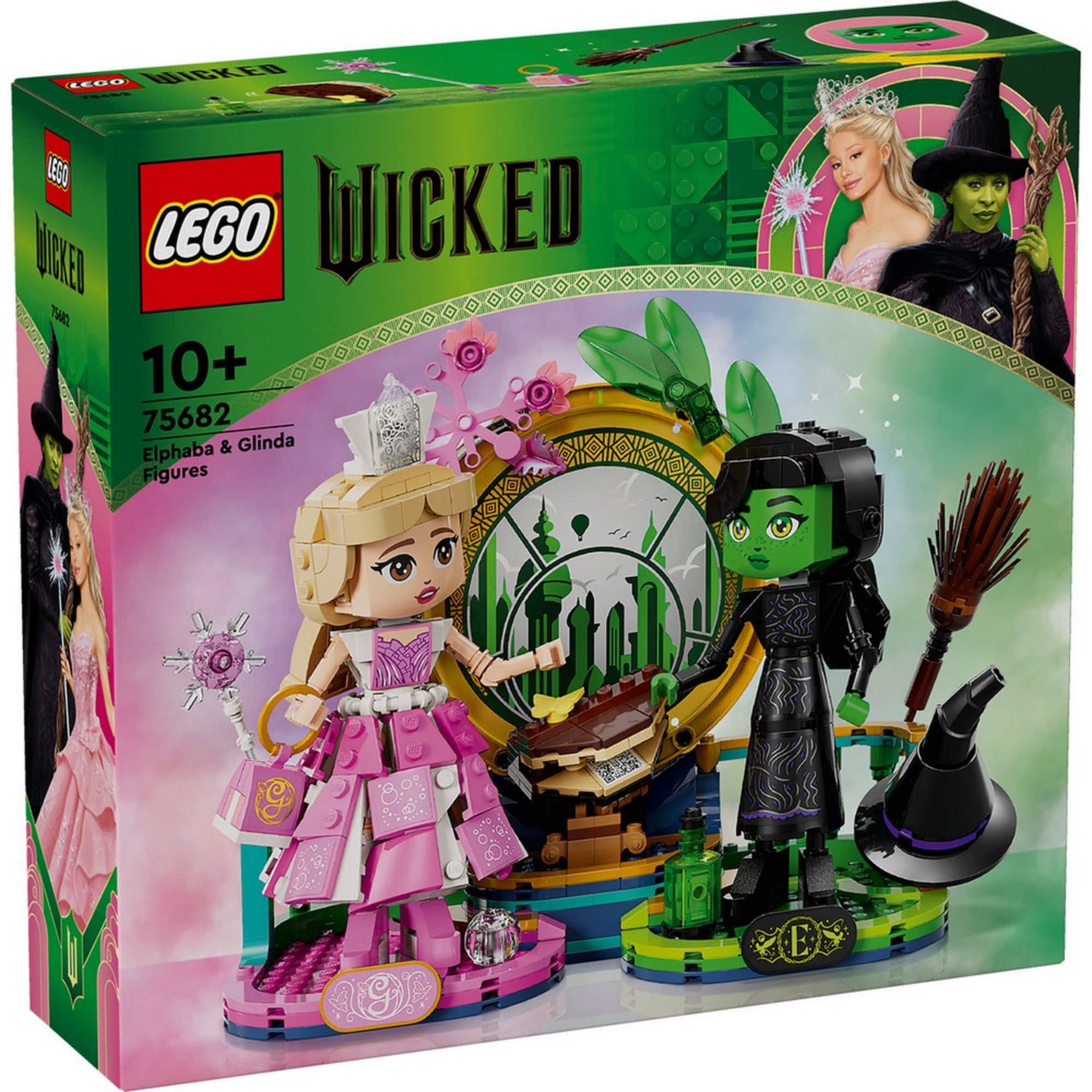 A készlet doboza, amely Elphaba és Glinda figuráit, valamint a varázslatos zöld dekorációt mutatja be a háttérben a Smaragdvárossal.