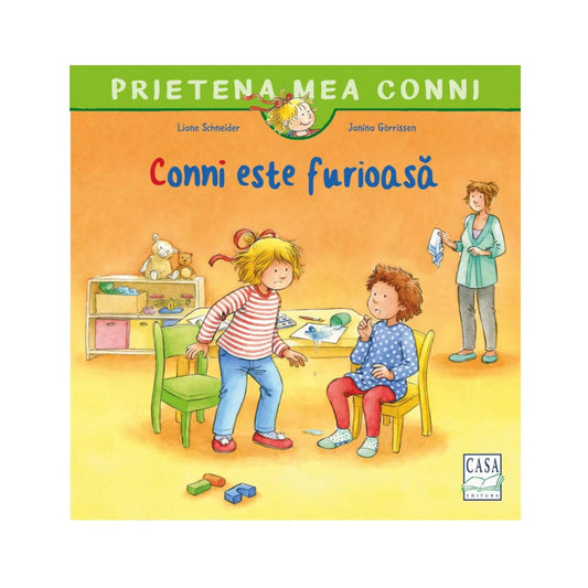 A könyvborító látható a képen: „Prietena mea Conni – Conni este furioasă”. A rajzolt illusztráción Conni dühösen áll egy zöld szék mellett, vele szemben egy kisfiú ül sárga széken, miközben egy felnőtt nő mosolyogva figyeli őket a háttérből.