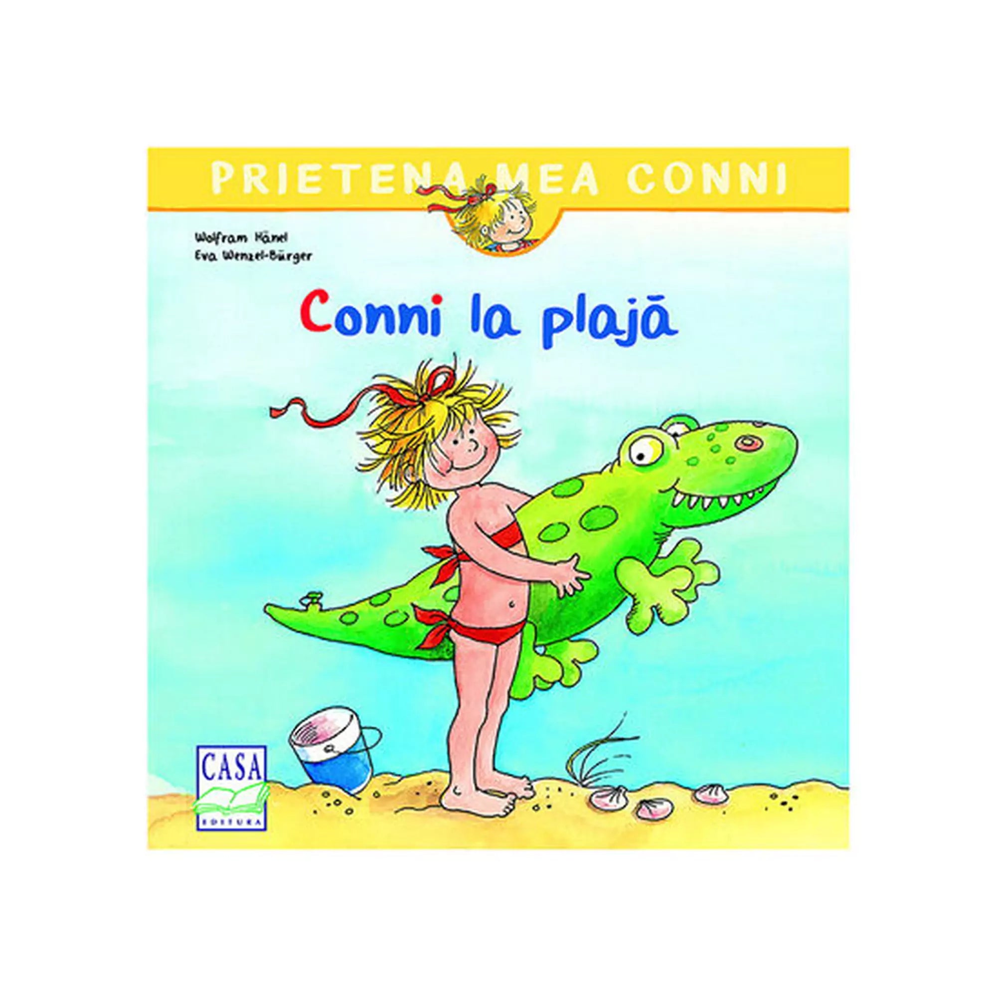 „A Conni la plajă román nyelvű mesekönyv borítója, amelyen Conni piros fürdőruhában áll a tengerparton, kezében zöld felfújható krokodilját, Fridolint tartva.”