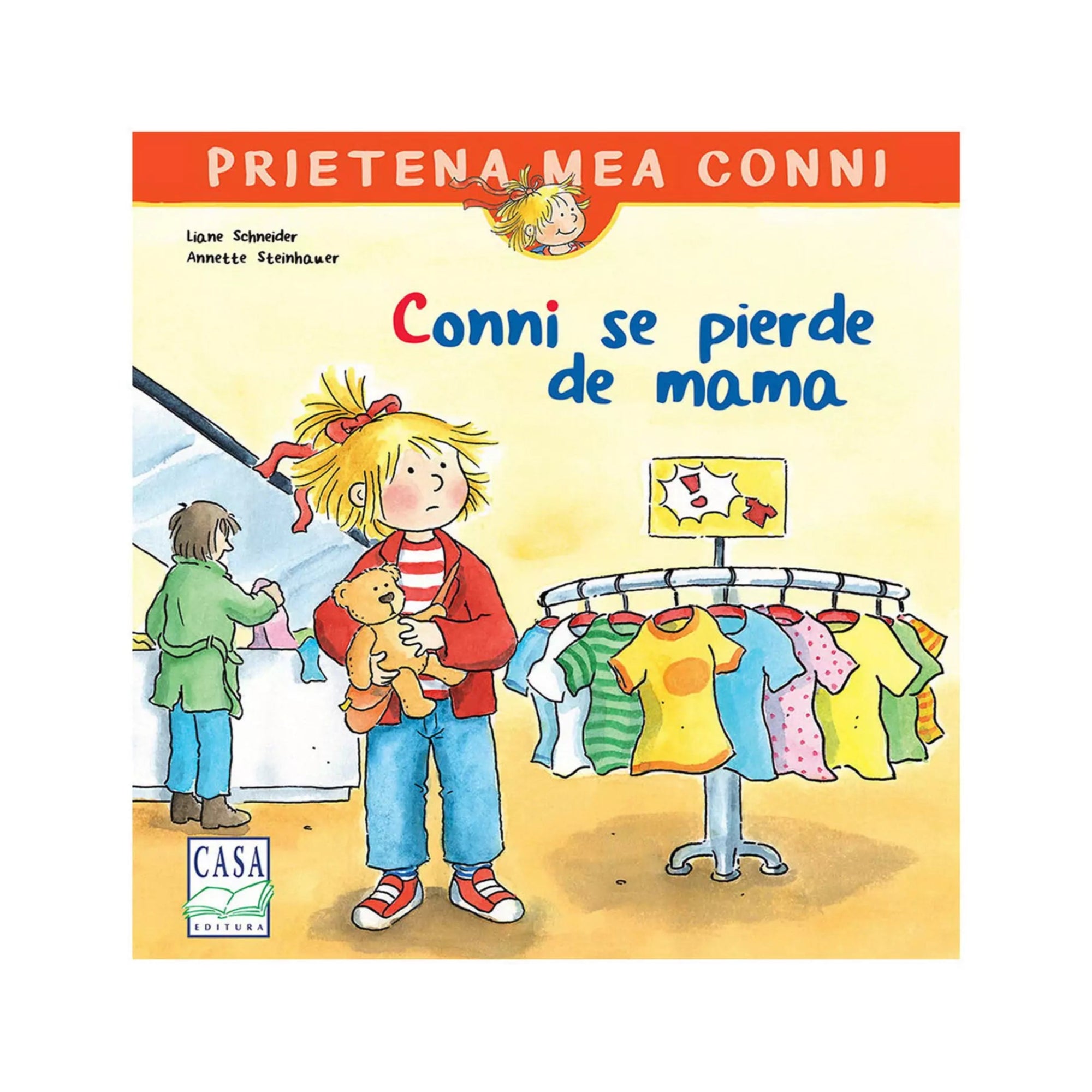 A kép a „Conni se pierde de mama” című gyerekkönyv borítóját ábrázolja. A rajzon Conni egy plüssmackót szorongatva áll egy ruhaboltban, mellette színes pólók lógnak egy állványon, a háttérben egy felnőtt alak látható a pénztárnál.