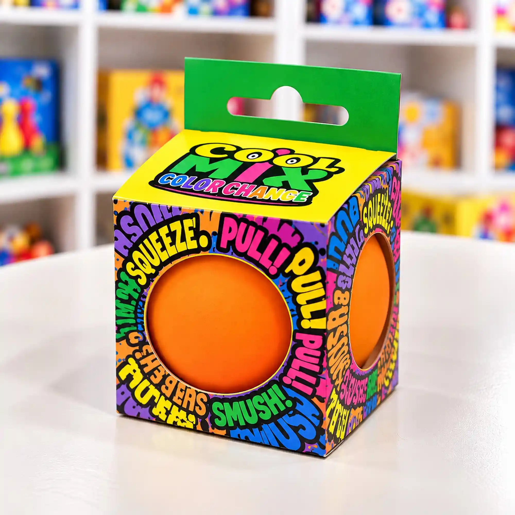 Cool Mix színváltós squishy stresszlevezető játék (narancssárga), színes feliratokkal díszített dobozban, két kerek nyíláson keresztül látható narancssárga labdával.
