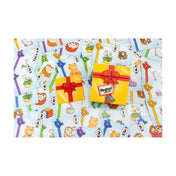 A Meglepi! társasjáték színes játékkártyái ajándékdoboz mintás háttéren, különböző tárgyakkal, mint plüssmaci, virág és Rubik-kocka.