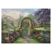 Thomas Kinkade Hummingbird Cottage puzzle illusztráció, idilli kertkapu virágos boltívvel, kanyargó kőösvénnyel és barátságos vidéki házzal, festményszerű, részletgazdag tájkép.