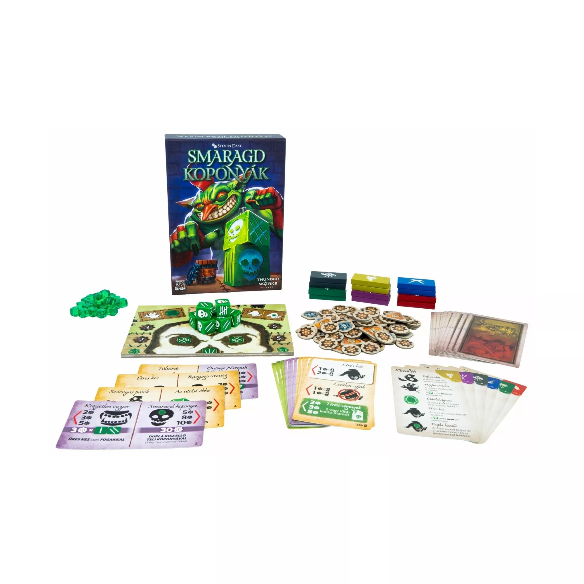 Smaragd Koponyák társasjáték teljes tartalma kiterítve: dobókockák, játéktábla, kártyák, jelölők és pontozóelemek